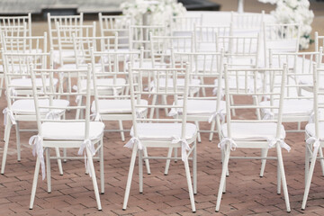 Outdoor area for wedding ceremonies with white chairs