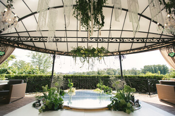 A place for wedding registration with fresh flowers and chandeliers with beads .