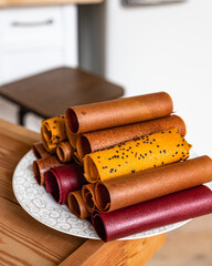 Assorted of fruit and berry marshmallow on white ceramic dish. Pastille fruit rolls. Healthy raw sweets. Diet vitamin food and vegan food.