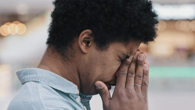 African american guy young frustrated upset man businessman immigrant worried about world crisis despair war news sadness headache stress economic default sanctions disaster emotions racism side view