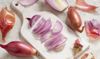 Sliced Red tropea onions on a white board close up - obrazy, fototapety, plakaty