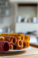 Assorted of fruit and berry marshmallow on white ceramic dish. Pastille fruit rolls. Healthy raw sweets. Diet vitamin food and vegan food.