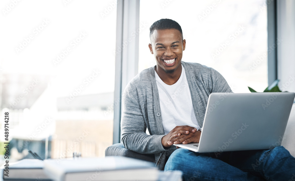 Poster uncapped wifi at home what more do you need. portrait of a happy young man using a laptop while rela