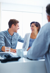Happy couple discussing with advisor. Portrait of happy couple laughing while discussing with financial advisor.