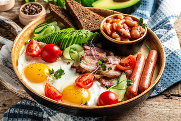 Healthy nutritious paleo keto breakfast diet Fried eggs, bacon, avocado, cheese and fresh salad. Keto breakfast or lunch. banner, catering menu recipe place for text, top view
