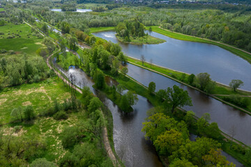 A panoramic view from a height of the ponds and the Landscape Park in Peterhof, the meadow garden, walking paths, the destroyed pavilion.