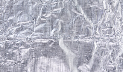 Foil silver crumpled metal aluminum texture background surface decoration backdrop design photo.