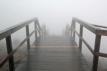 Foggy staircase with railing in high mointains