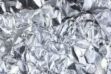 Foil silver crumpled metal aluminum texture background surface decoration backdrop design photo.