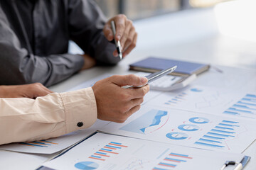 The atmosphere in the meeting room where the businessmen are meeting, information papers and charts are placed on the table to support the business planning meeting to grow. Business idea.
