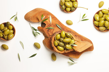 Green olives in wooden bowls on white background