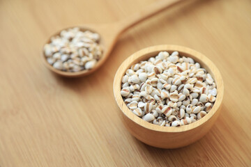 Fresh organic millet or job's tear seed on sack in bowl  in kitchen for cooking in daily life meal. selective focus. top view.