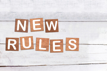  New rules sign made of wood on a desk 