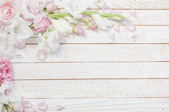 pink and white flowers on white wooden background