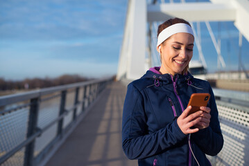 Young fitness woman running and exercising on the bridge