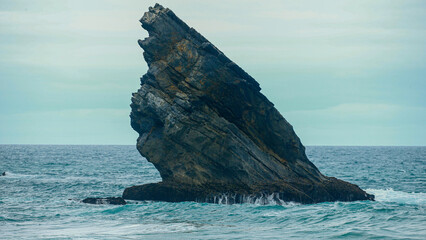 beautiful rock in middle of ocean