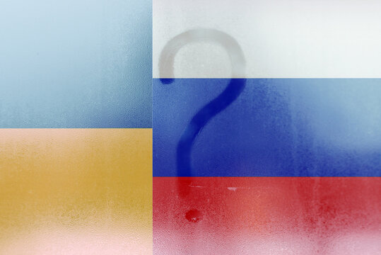 Flags of Russia vs Ukraine double exposure drawn question mark on the dewy window.