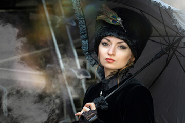 A beautiful girl in a historical retro dress against the background of an old steam locomotive at the station.