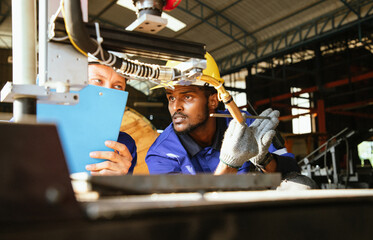 Group engineer worker wearing safety goggles repair or maintenance robotics machine to weld components of nut and steel. Metal lathe industrial manufacturing factory indoors. Dreaming future projects