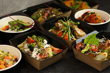 Healthy food delivery. A set of dishes for the diet on a black background. Top view. Free space for...