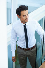 Going to the top. A handsome young businessman walking up the stairs.
