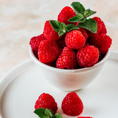 fresh ripe raspberries on a light pink background