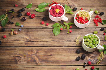 different berries on old wooden background