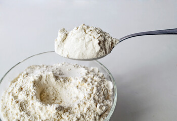 Premium wheat flour, flour in a tablespoon, the process of mixing ingredients for cooking