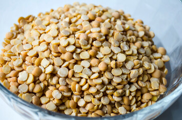 Dried natural pea grains in a glass container