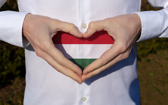 man holidng his hands in heart shaped on white shirt with hungarian flag tricolor colors symbol of the hungarian national day 15th of march