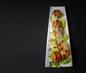 Japanese food in a white plate on black background. Top view. Banner