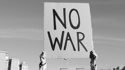 Stop war protest - People on street fighting for peace and human rights - Focus on banner sign - Black and white edition