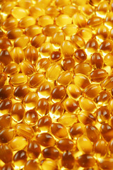 Golden Vitamin D3 Capsules close-up in full screen