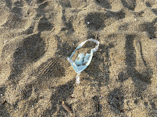 Medical waste mask ,mask on the beach , coronavirus covid pollution
