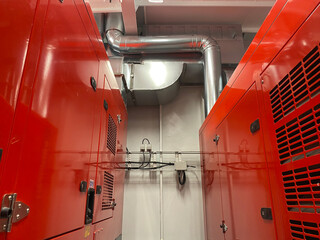 ship engine room with generators and hvac duct piping