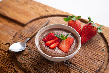 Chocolate mousse with pieces of fresh strawberry.