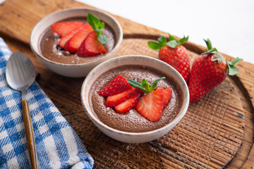 Chocolate mousse with pieces of fresh strawberry.