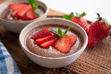 Chocolate mousse with pieces of fresh strawberry.