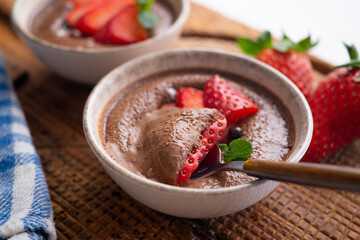 Chocolate mousse with pieces of fresh strawberry.