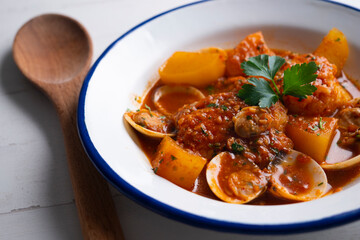 Cod with potatoes and clams. Traditional recipe from the north of Spain.