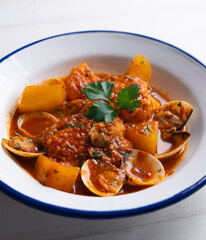 Cod with potatoes and clams. Traditional recipe from the north of Spain.