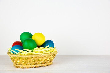 Easter eggs in brown bowl. Happy Easter holiday. Colorful painted eggs. Bright boiled eggs.