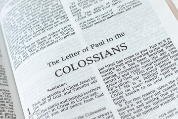Colossians open Holy Bible Book close-up. New Testament Scripture. Studying the Word of God Jesus Christ. Christian biblical concept of faith, hope, and trust.	