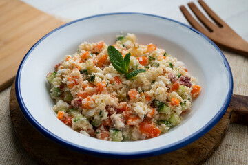 Fake couscous made with crushed cauliflower, green pepper and other vegetables. vegan recipe.