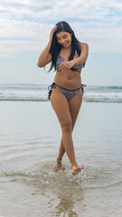 Obraz premium young beautiful and happy Asian Indonesian woman in bikini enjoying holidays at tropical beach in Bali enjoying holidays and travel