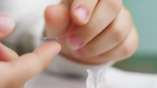 close-up. on contact lens on a child's finger drip eye drops. 