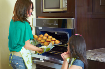 These look perfect. Cute little girl baking with her nanny at home.