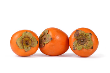 Three Kaki Persimmon fruits in a row on white background