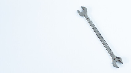 Old rusty double spanner or wrench key tool isolated on white background. Copy space. Top view.