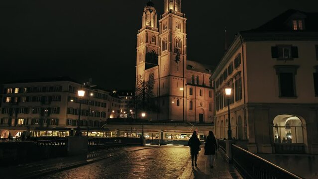 Night architecture of Grossmünster Protestant church in the old town in Zürich. A Swiss traditional design of the 12th century twin-towered Romanesque cathedral in the nighttime.